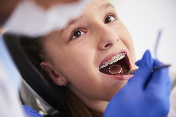 Girl with braces during a routine, dental examination Girl with braces during a routine, dental examination